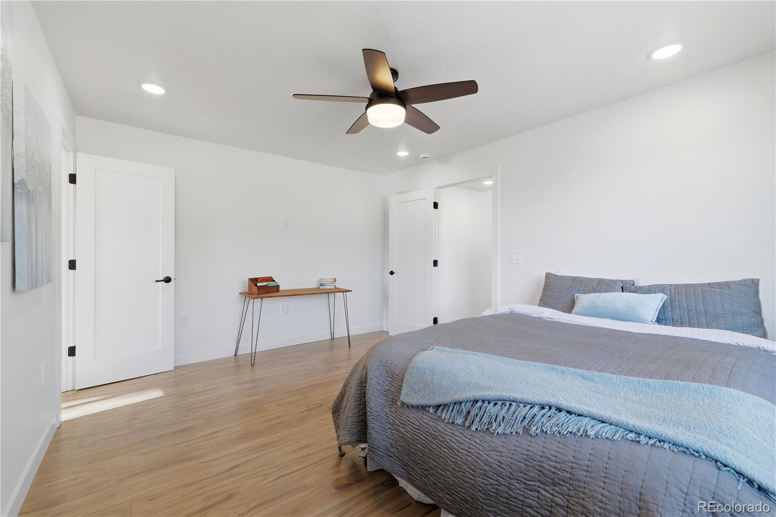 901 Garrison Street Lakewood, CO 80215 - Photo 12 of 47 a bedroom with a bed and a ceiling fan
