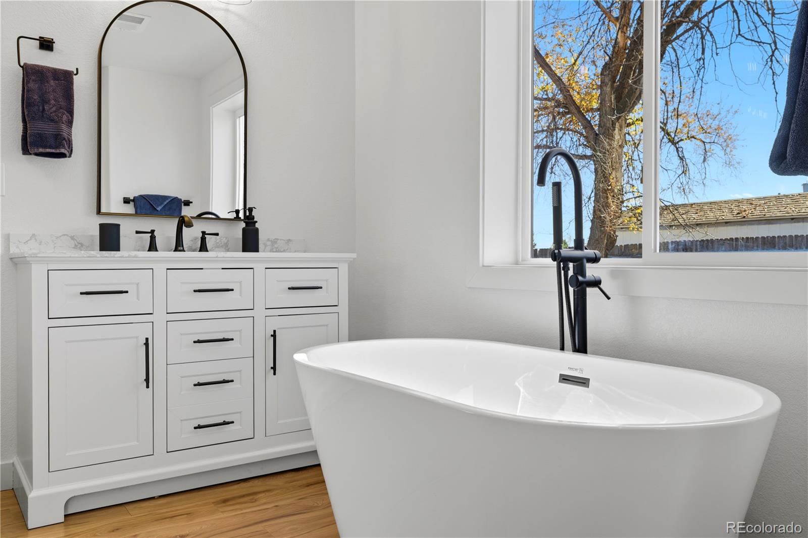 901 Garrison Street Lakewood, CO 80215 - Photo 14 of 47 a bathroom with a sink and a mirror