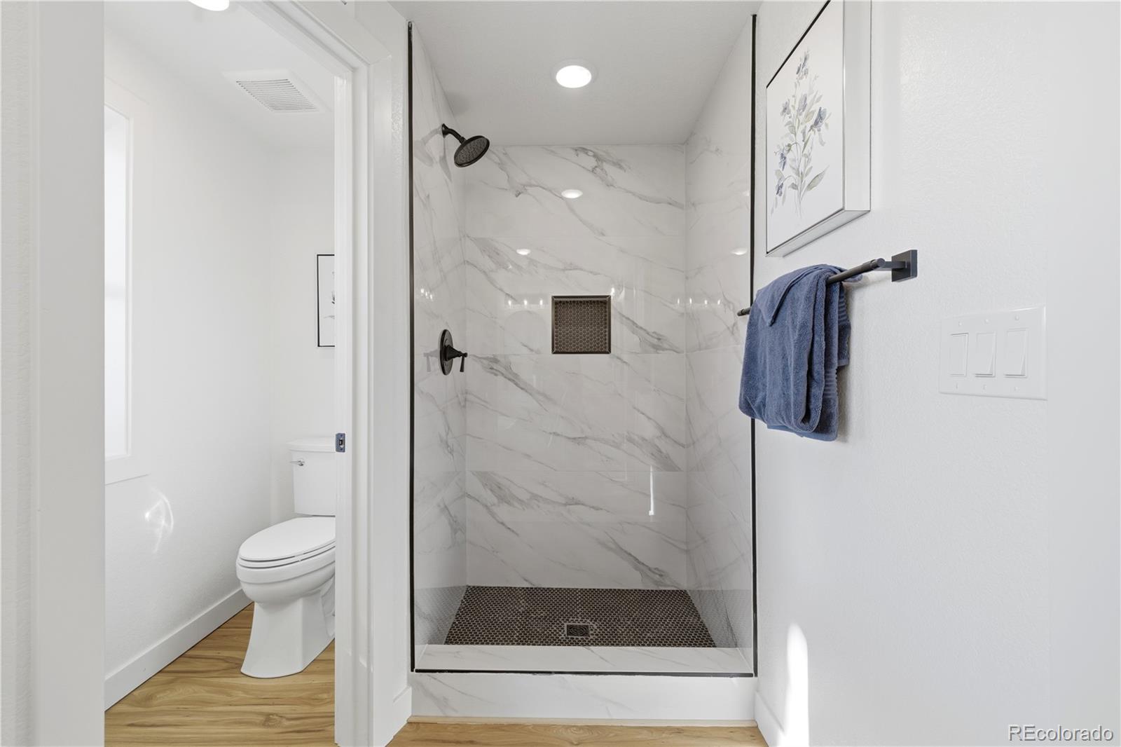 901 Garrison Street Lakewood, CO 80215 - Photo 16 of 47 a bathroom with a shower and toilet