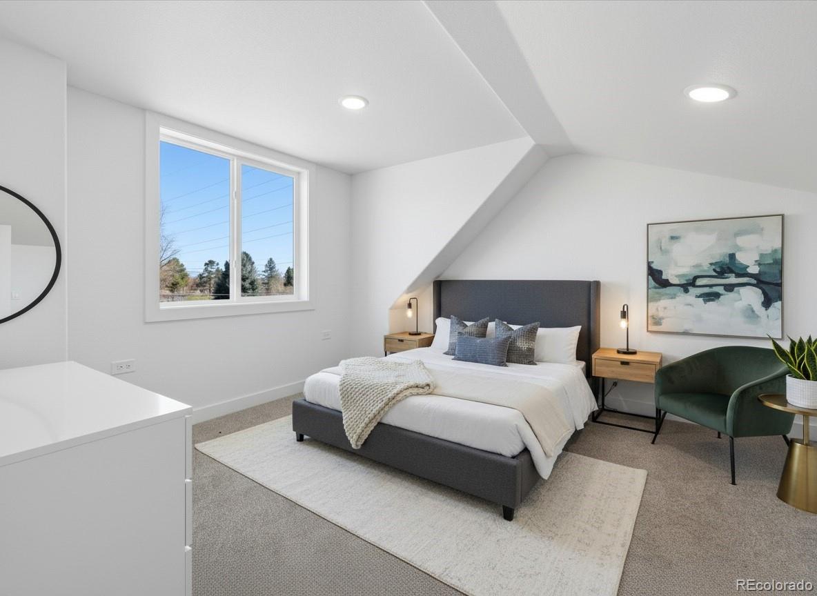 901 Garrison Street Lakewood, CO 80215 - Photo 19 of 47 a bedroom with a large bed couch and a window