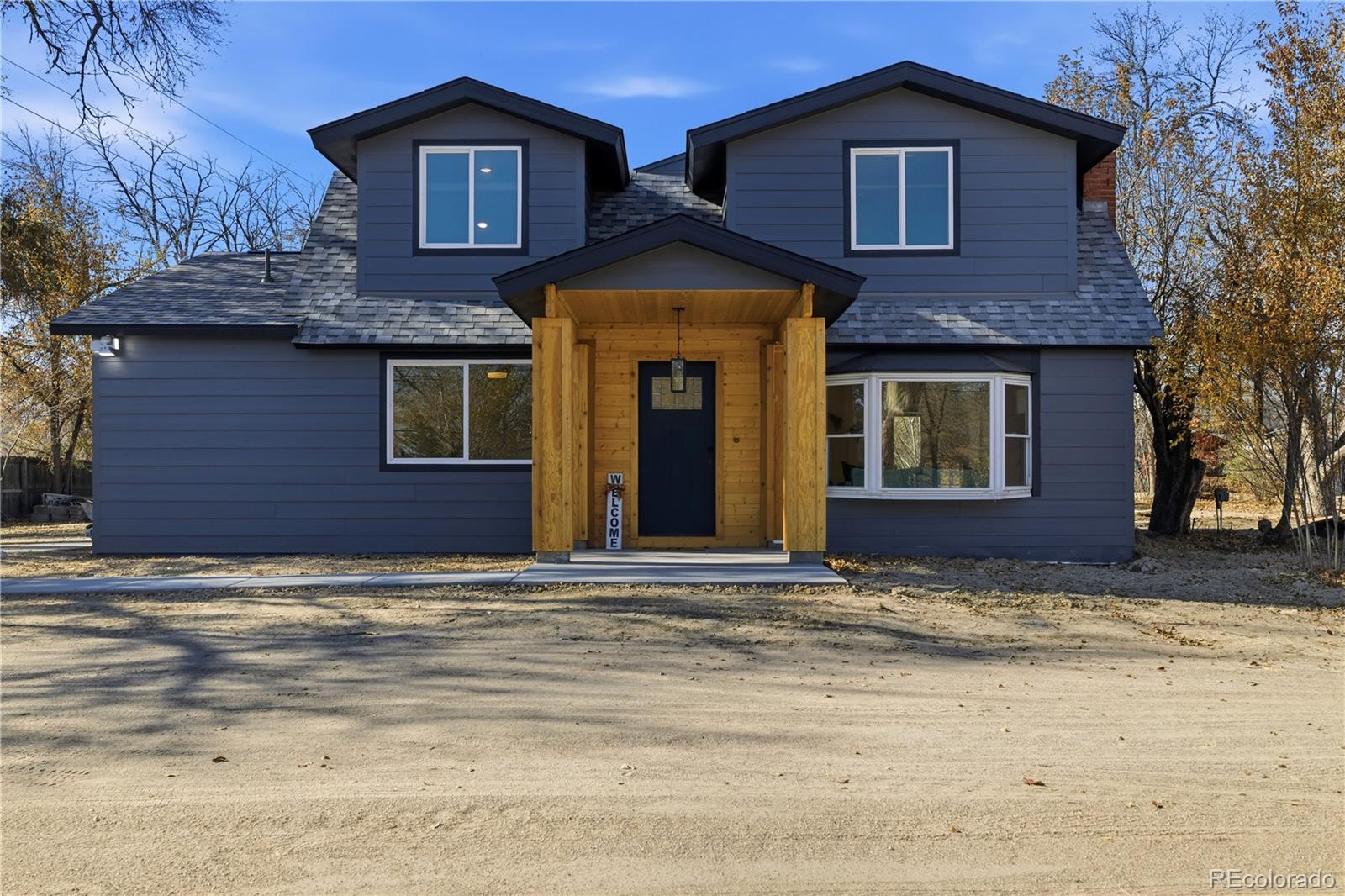 901 Garrison Street Lakewood, CO 80215 - Photo 2 of 47 a view of a brick house with a large windows
