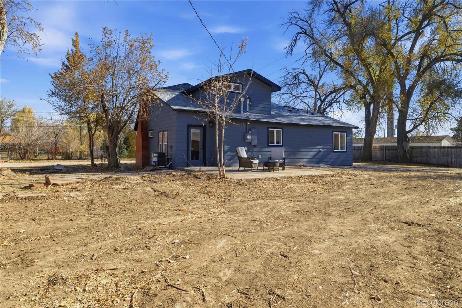 901 Garrison Street Lakewood, CO 80215 - Photo 25 of 47 a front view of a house with a yard
