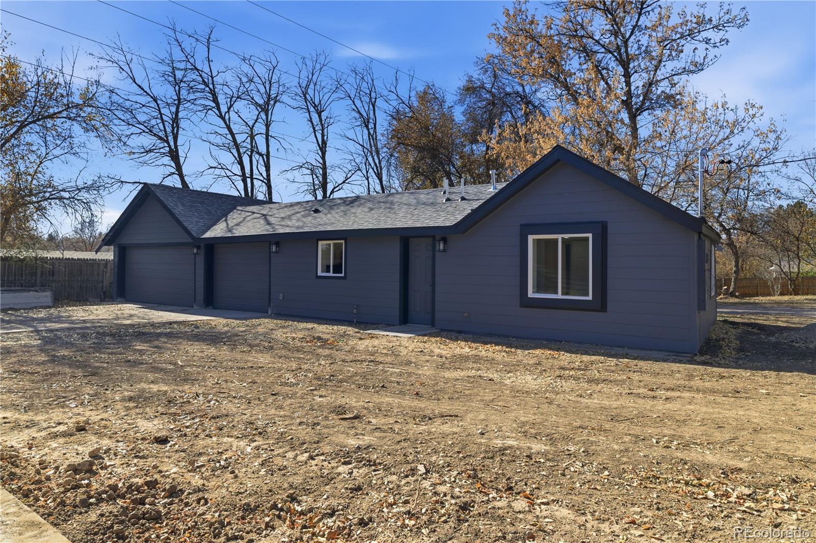901 Garrison Street Lakewood, CO 80215 - Photo 27 of 47 a house with trees in front of it