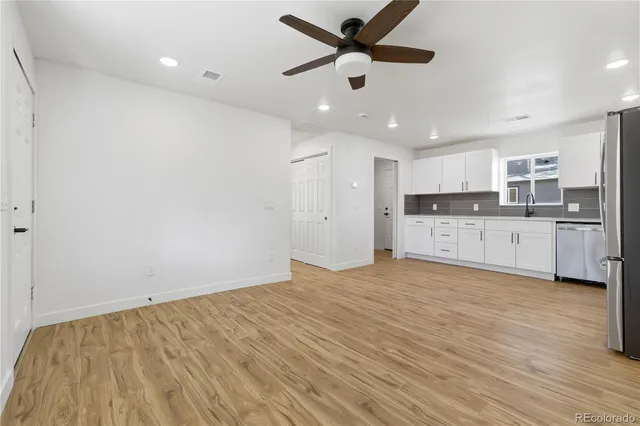 a view of a kitchen with a sink and cabinets
