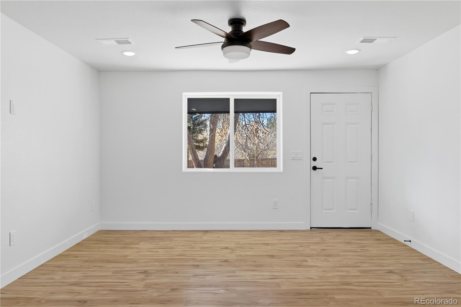 901 Garrison Street Lakewood, CO 80215 - Photo 30 of 47 wooden floor in an empty room with a window