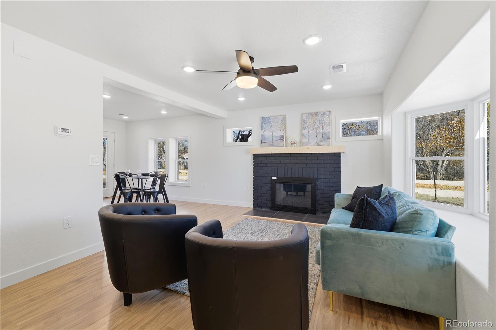 901 Garrison Street Lakewood, CO 80215 - Photo 3 of 47 a living room with furniture a window and a fireplace