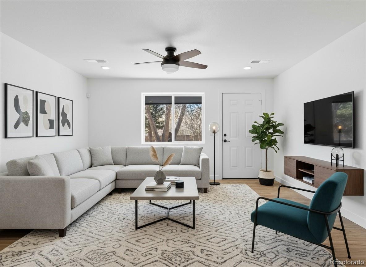 901 Garrison Street Lakewood, CO 80215 - Photo 31 of 47 a living room with furniture and a flat screen tv