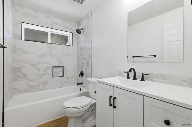 a bathroom with a sink a toilet and a bathtub