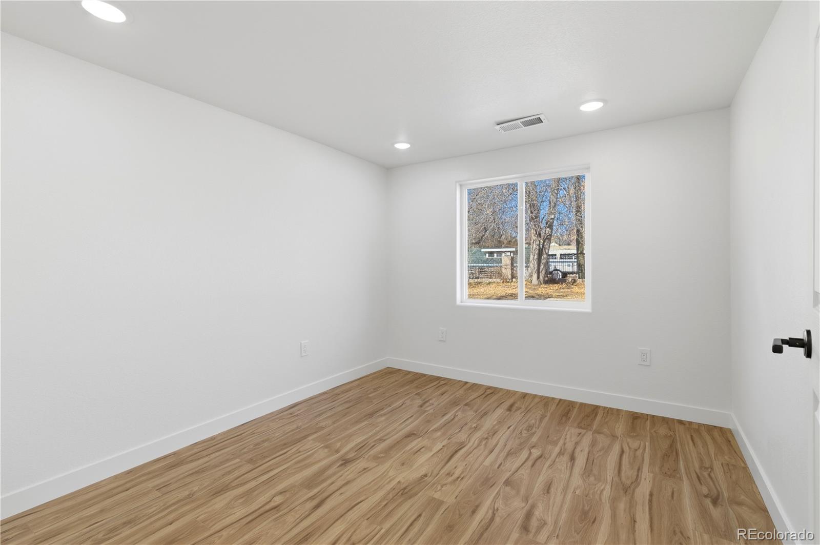 901 Garrison Street Lakewood, CO 80215 - Photo 36 of 47 a view of empty room with wooden floor and fan