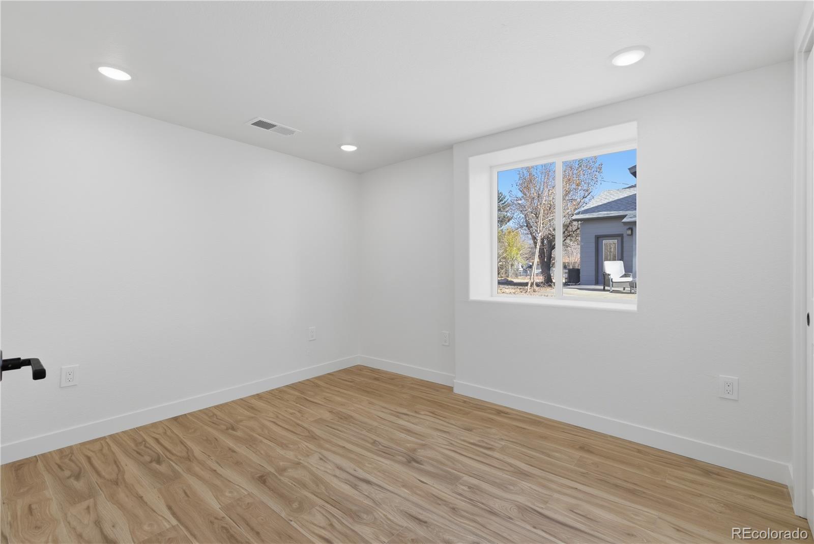 901 Garrison Street Lakewood, CO 80215 - Photo 38 of 47 a view of empty room with wooden floor