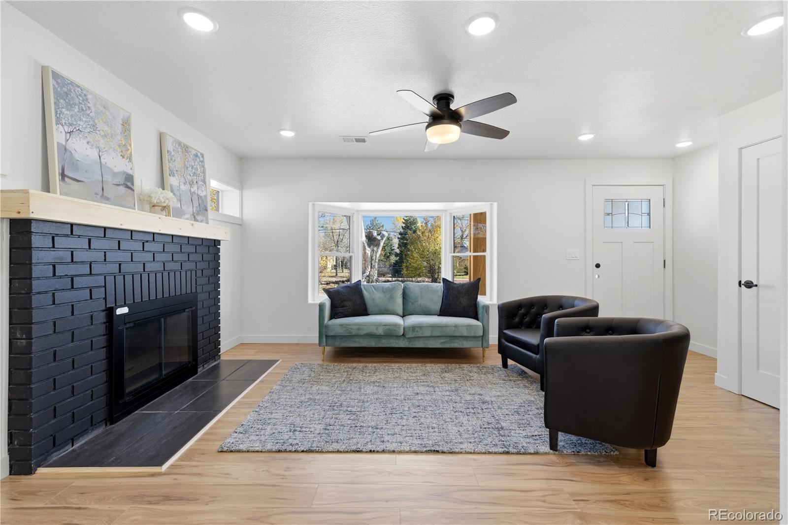 901 Garrison Street Lakewood, CO 80215 - Photo 4 of 47 a living room with furniture and a fireplace