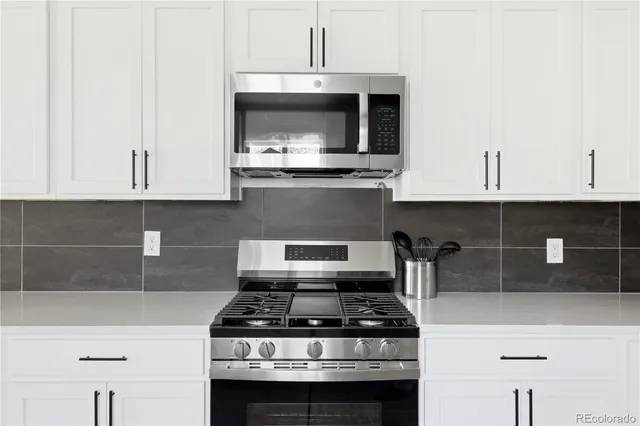 a stove top oven sitting inside of a kitchen
