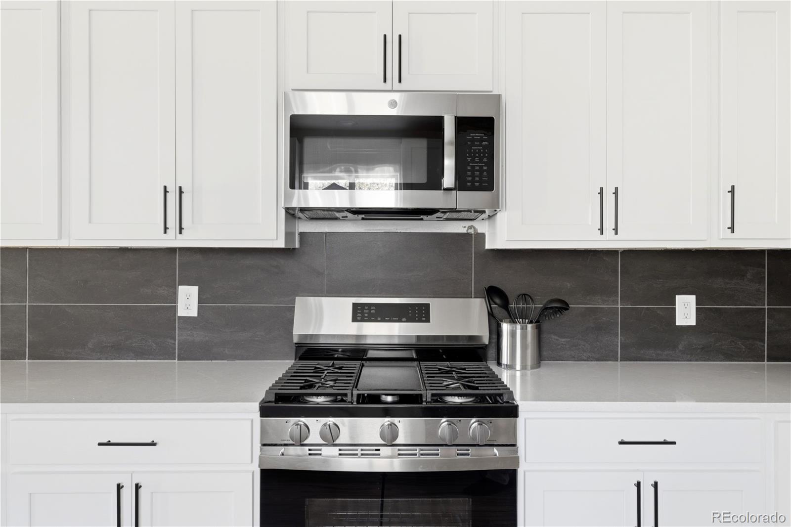 901 Garrison Street Lakewood, CO 80215 - Photo 10 of 47 a stove top oven sitting inside of a kitchen