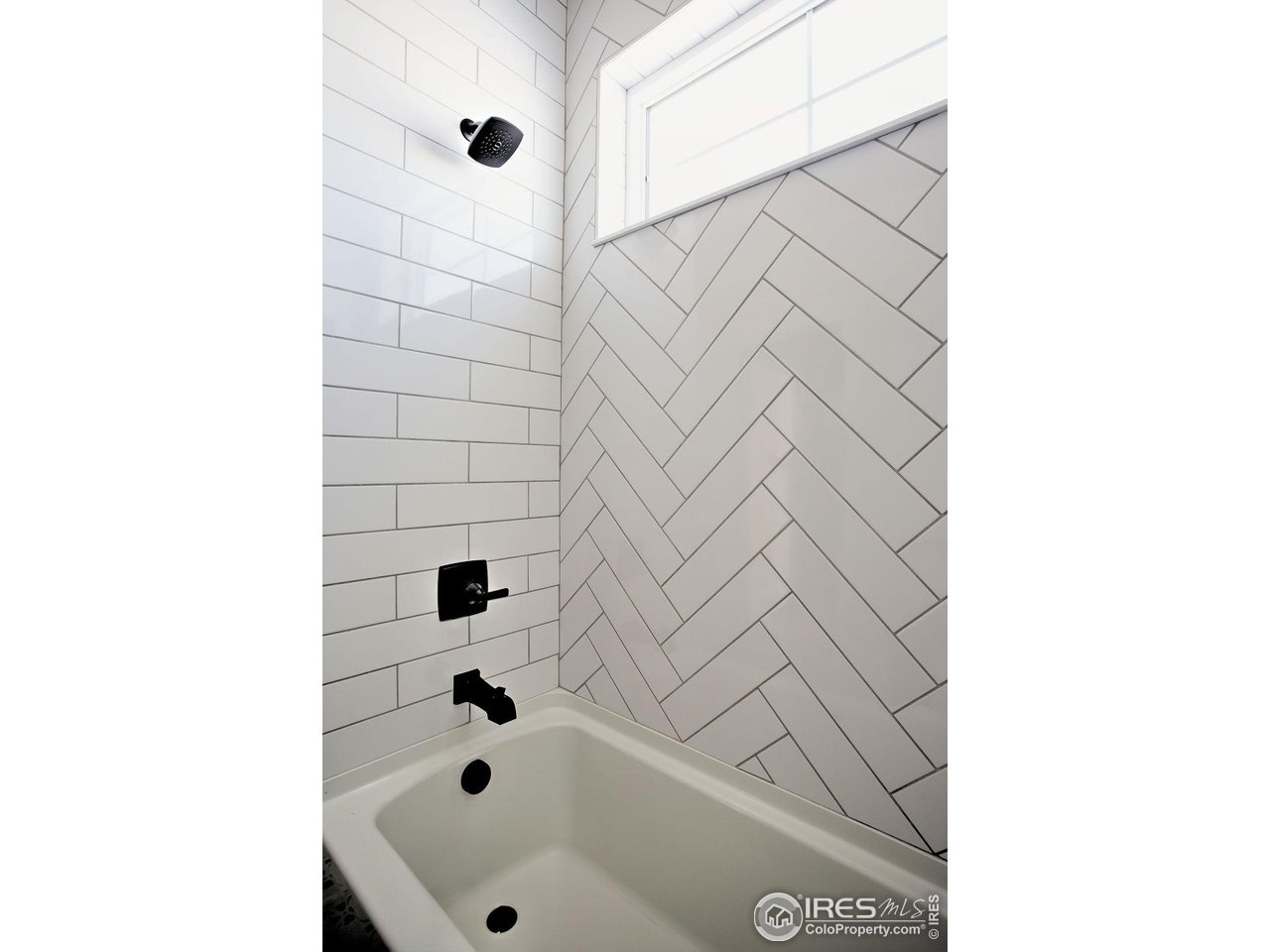 15261 Ypsilon Circle Mead, CO 80542 - Photo 15 of 15 a bathroom with a bathtub and shower