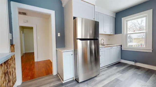 a kitchen with a refrigerator a sink and cabinets