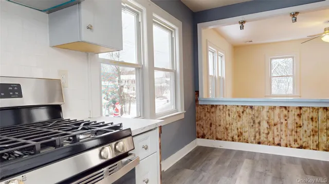 a kitchen with stainless steel appliances granite countertop a stove and a window