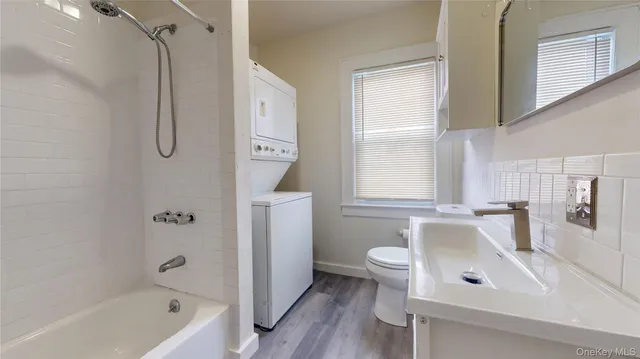 a bathroom with a tub sink and mirror