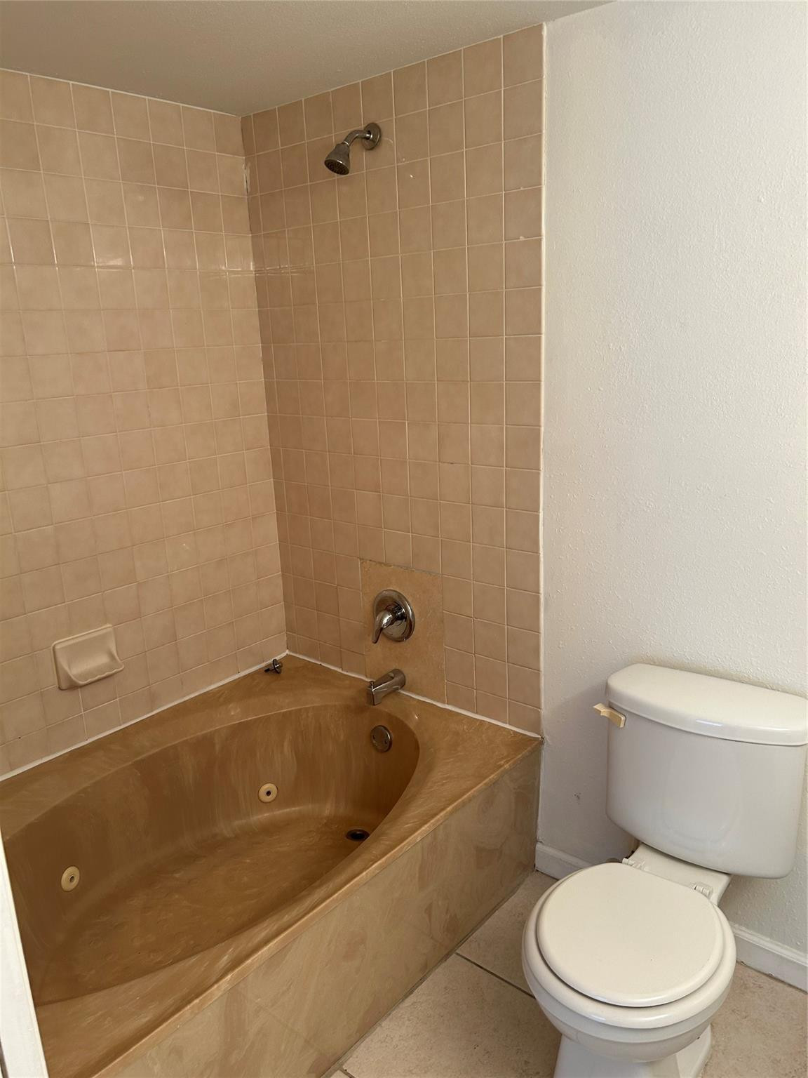 8117 Severn Drive, Unit C Boca Raton, FL 33433 - Photo 7 of 11 a white toilet sitting next to a bath tub