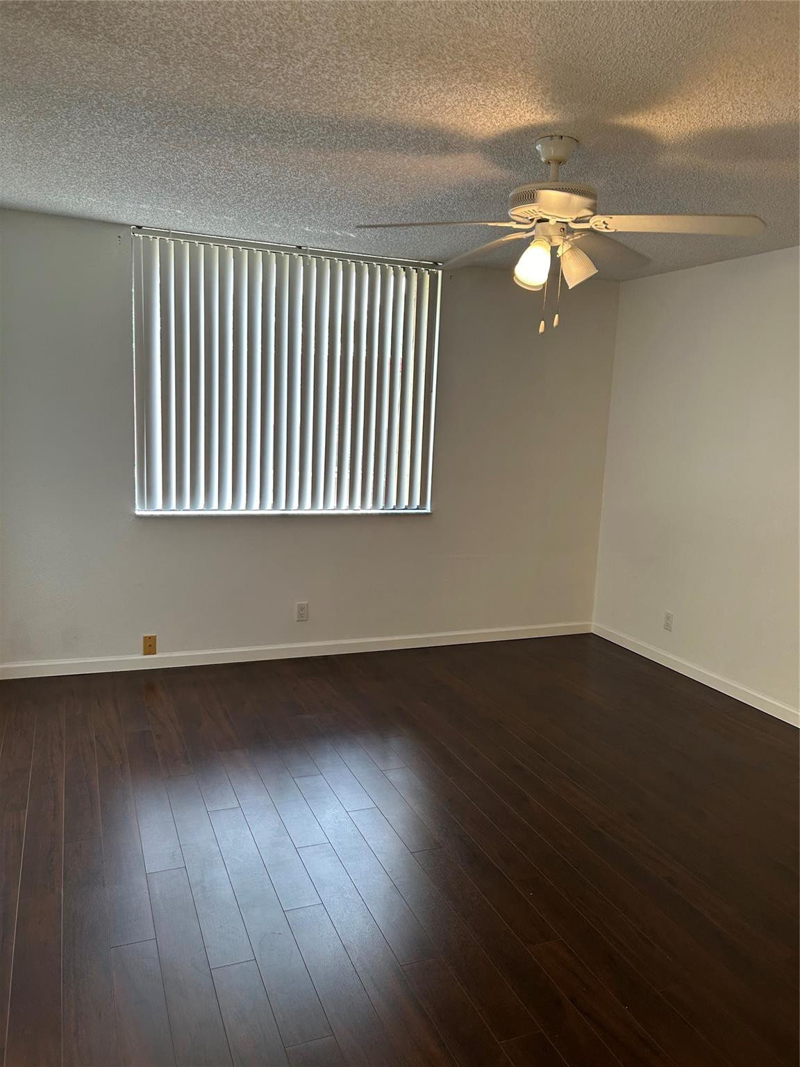 8117 Severn Drive, Unit C Boca Raton, FL 33433 - Photo 9 of 11 an empty room with wooden floor and windows
