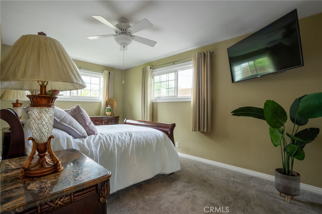 415 South Taper Avenue Compton, CA 90220 - Photo 14 of 32 a living room with furniture a chandelier and a flat screen tv