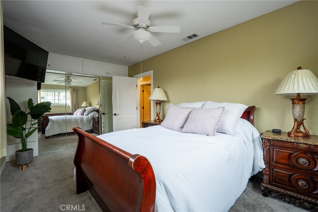 415 South Taper Avenue Compton, CA 90220 - Photo 15 of 32 a bed room with a bed a couch and a chandelier