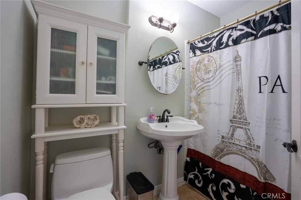 415 South Taper Avenue Compton, CA 90220 - Photo 18 of 32 a bathroom with a sink mirror and shower