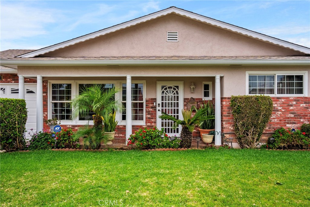 415 South Taper Avenue Compton, CA 90220 - Photo 2 of 32 front view of a house with potted plants and a yard