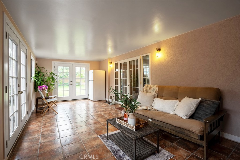 415 South Taper Avenue Compton, CA 90220 - Photo 22 of 32 a living room with furniture and a floor to ceiling window