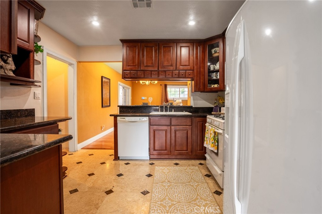 415 South Taper Avenue Compton, CA 90220 - Photo 10 of 32 a kitchen with stainless steel appliances granite countertop a stove a sink and a microwave