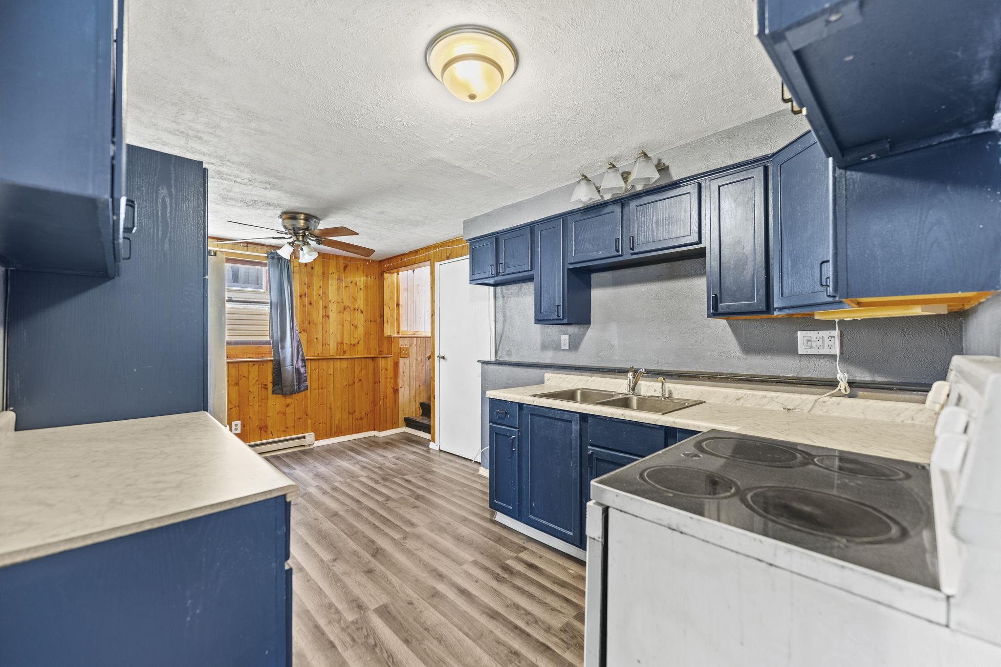 729 West Perry Street Belvidere, IL 61008 - Photo 11 of 27 a kitchen with stainless steel appliances granite countertop a sink a stove and a refrigerator