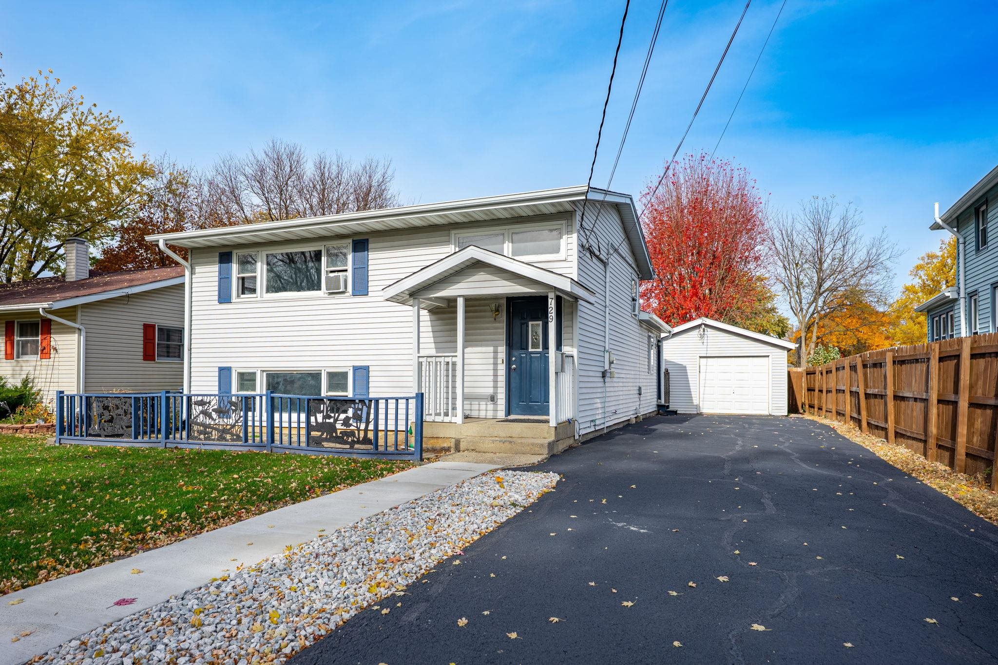 729 West Perry Street Belvidere, IL 61008 - Photo 2 of 27 a front view of a house with a garden and patio