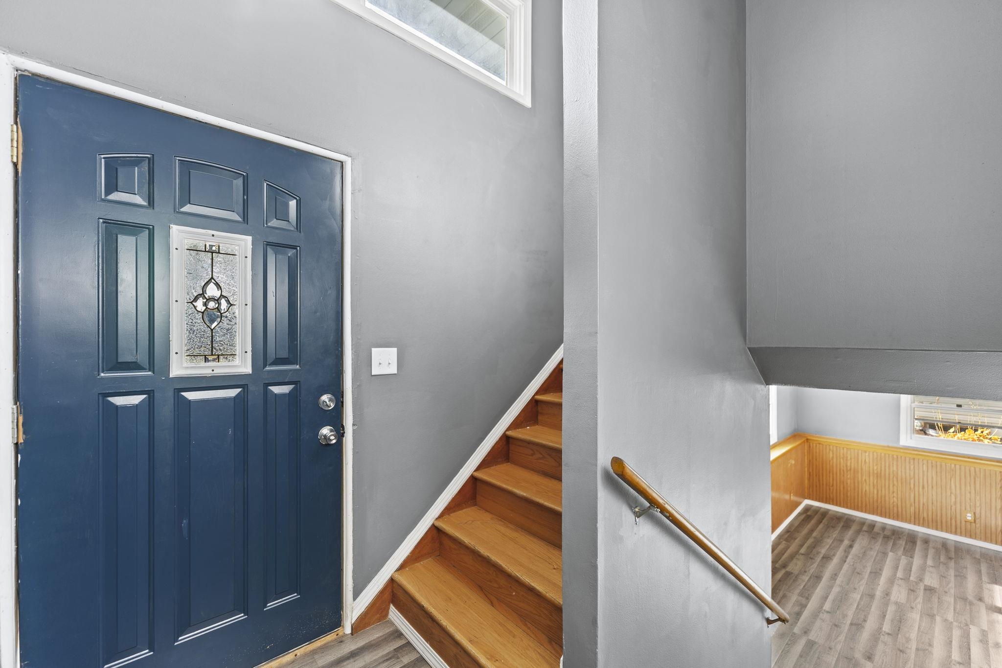 729 West Perry Street Belvidere, IL 61008 - Photo 4 of 27 a view of a hallway with wooden floor and stairs