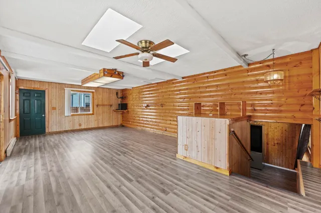 a view of a room with wooden floor