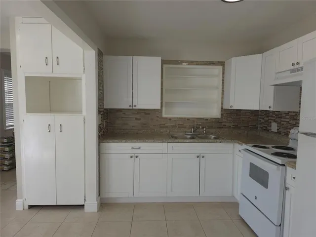 a kitchen with white cabinets