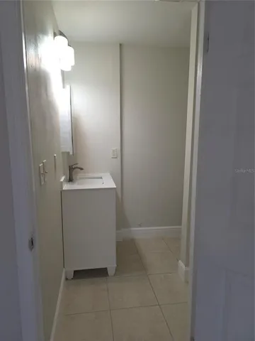 a bathroom with a sink a vanity and a mirror