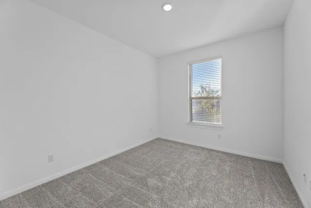 a swimming pool is in a big yard with lawn chairs