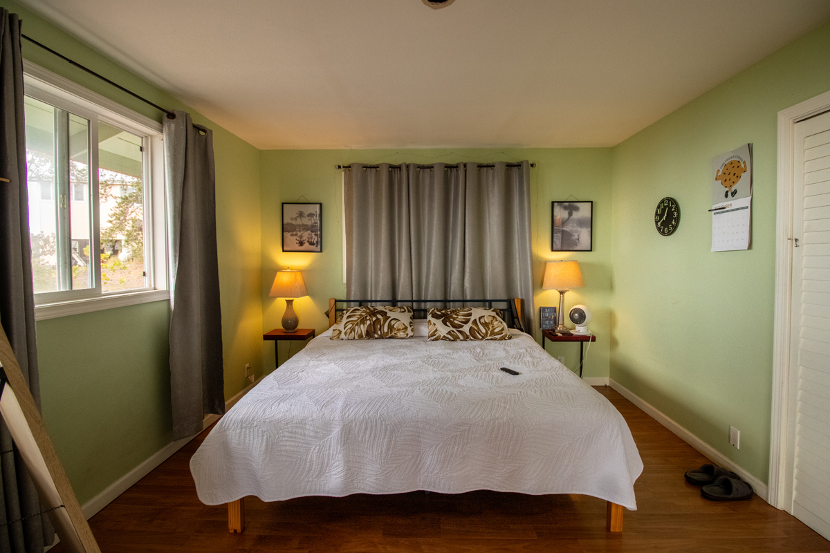92-8901 Tiki Lane Ocean View, HI 96704 - Photo 13 of 24 a bedroom with a bed and wooden floor