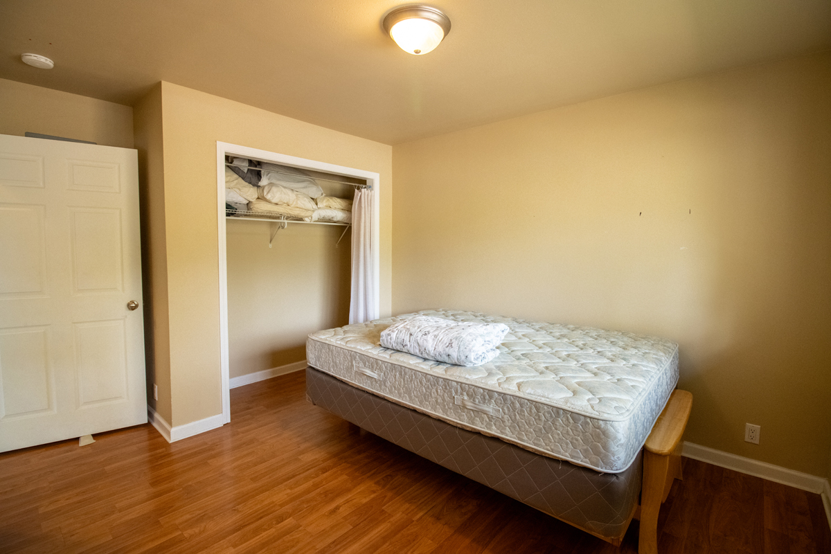 92-8901 Tiki Lane Ocean View, HI 96704 - Photo 15 of 24 a bedroom with a bed and wooden floor