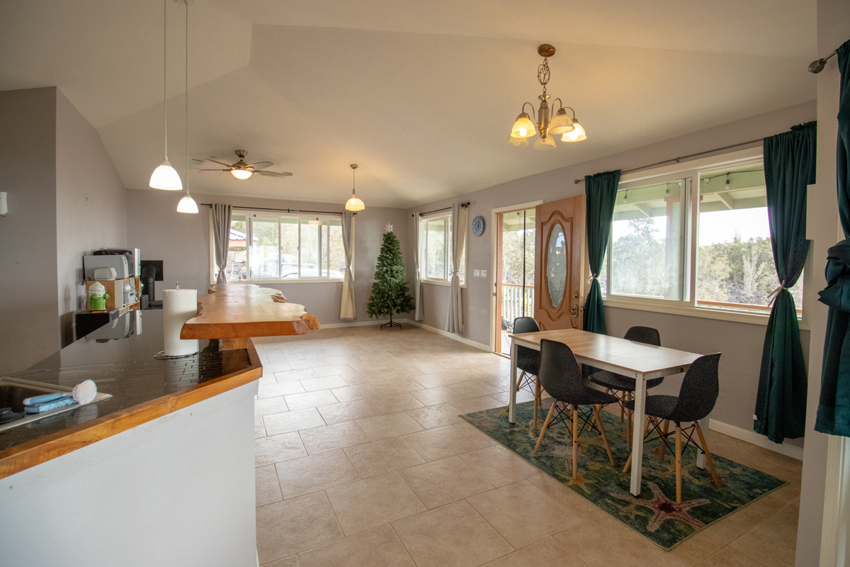 92-8901 Tiki Lane Ocean View, HI 96704 - Photo 17 of 24 a view of a dining room with furniture and a chandelier