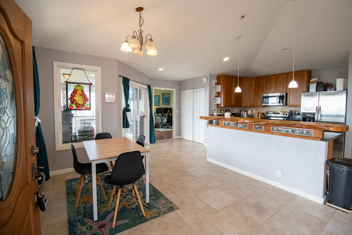 92-8901 Tiki Lane Ocean View, HI 96704 - Photo 18 of 24 a living room with stainless steel appliances kitchen island granite countertop furniture and a kitchen view