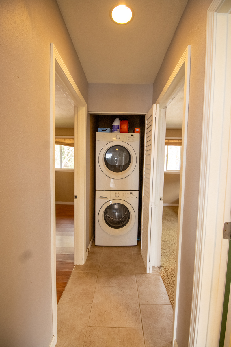 92-8901 Tiki Lane Ocean View, HI 96704 - Photo 23 of 24 a view of a hallway with washer and dryer