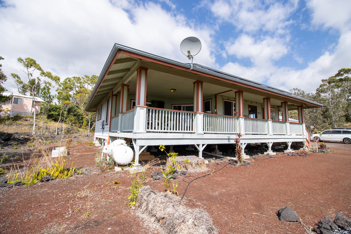92-8901 Tiki Lane Ocean View, HI 96704 - Photo 9 of 24 a front view of a house with a yard