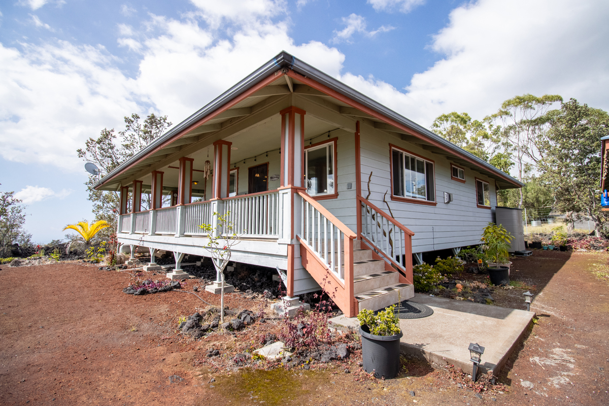 92-8901 Tiki Lane Ocean View, HI 96704 - Photo 10 of 24 a front view of a house with a yard