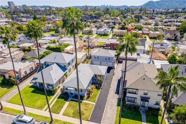 an aerial view of multiple houses with a swimming pool