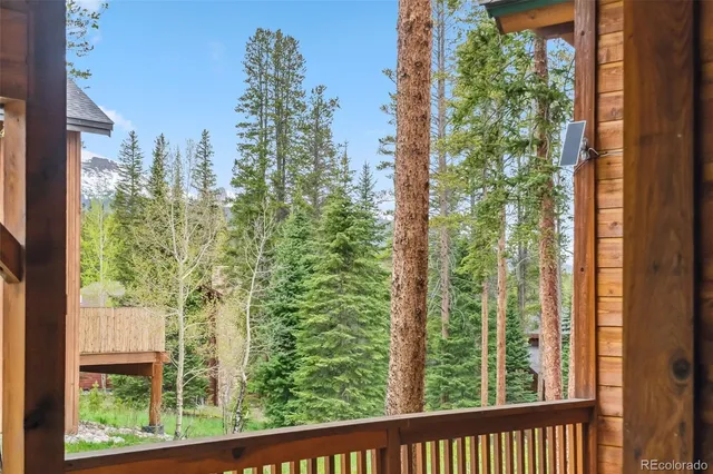 a house view with a garden and deck