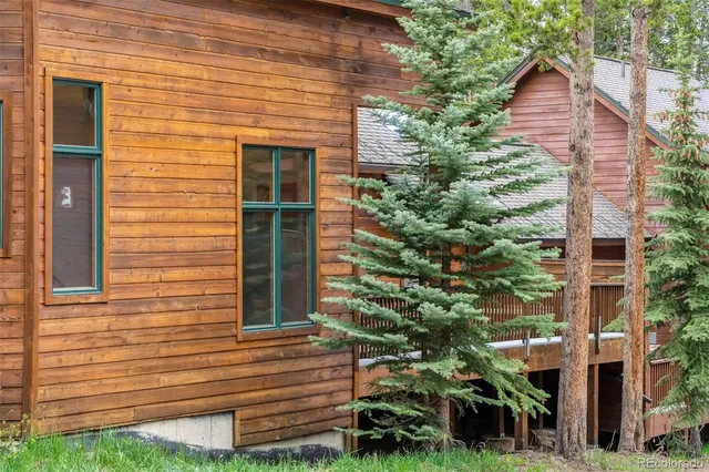 a view of house with a yard and potted plants