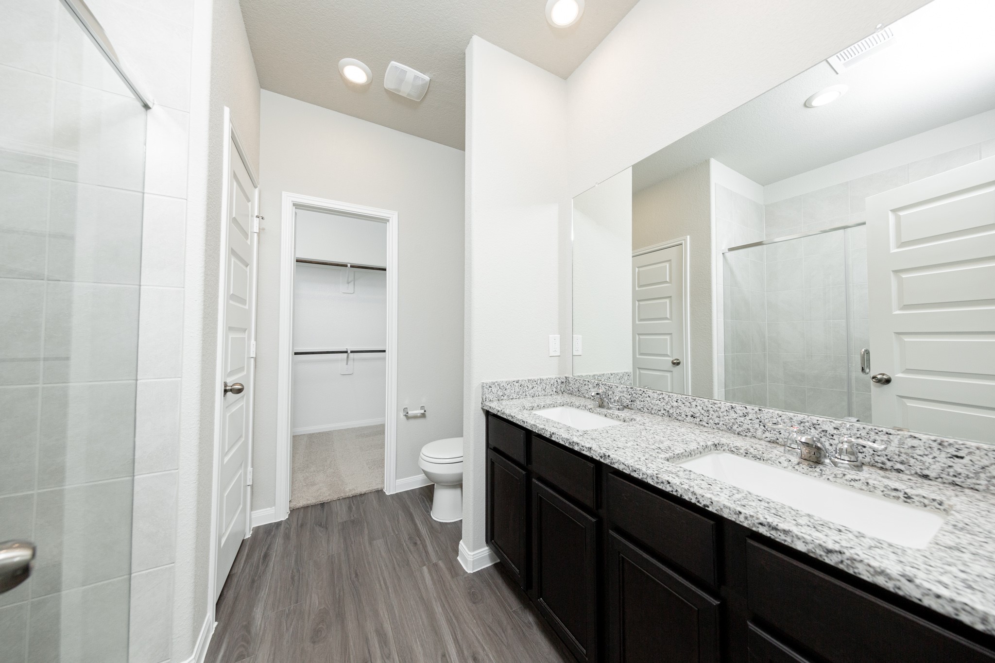 13687 Kit Run Splendora, TX 77372 - Photo 11 of 24 a bathroom with a granite countertop sink a toilet and shower