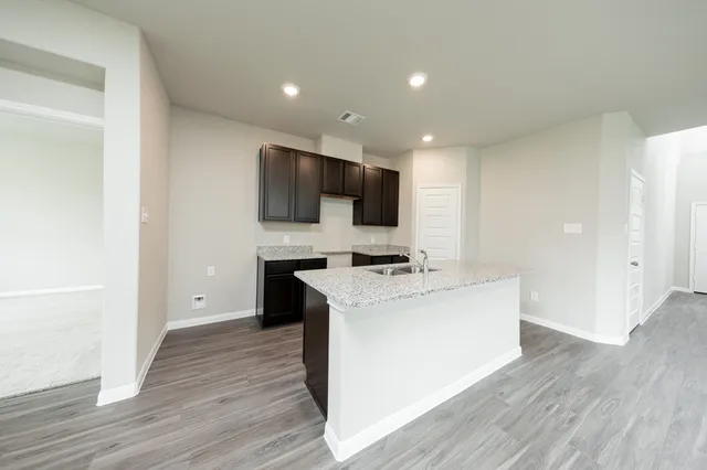 a living room with a flat screen tv furniture and a wooden floor