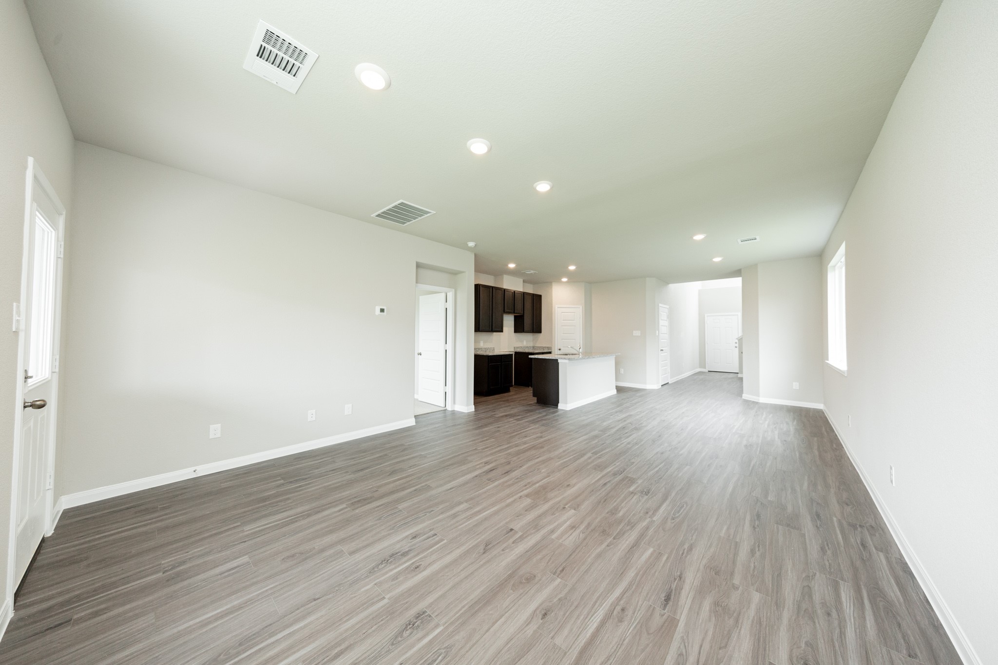13687 Kit Run Splendora, TX 77372 - Photo 8 of 24 an empty room with wooden floor and windows