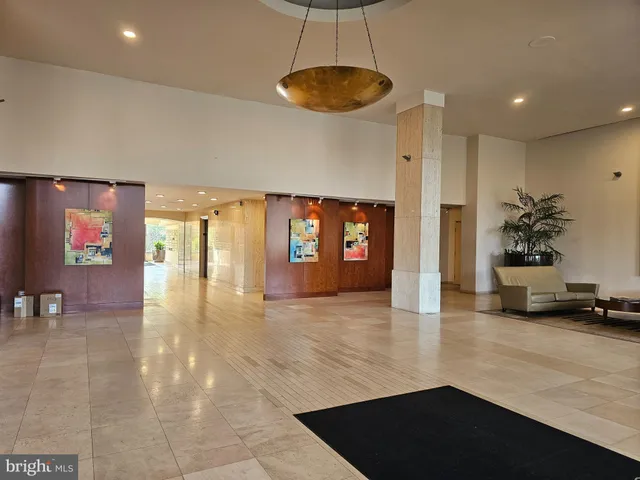 a lobby with furniture and floor to ceiling window